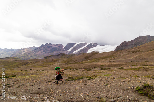 Peruvian person going down the mountain,panoramic view,Vinicunca,tourists and locals,, Seven Colors Mountain,Seven Colors Mountain,Trekking,Cusco, Perú.