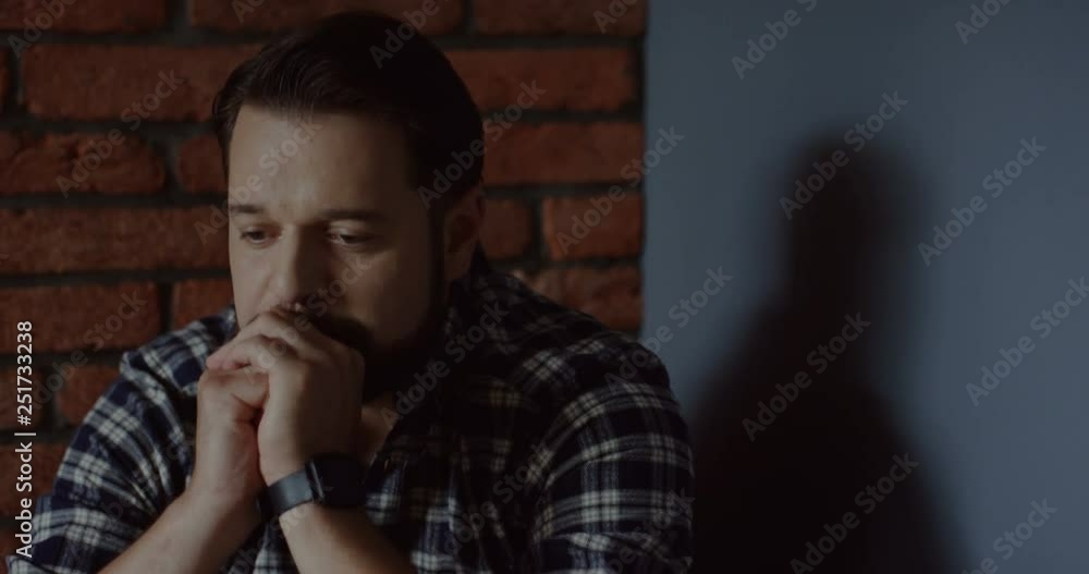 Good looking Caucasian man of middle age having a stress because of life problems while sitting in the corner. Good looking Caucasian man of middle age having a stress because of life problems while sitting in the corner.