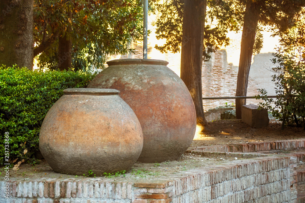 Large antique pots near of the ruins of the Flavian Amphitheater in Pozzuoli. Southern Italy. Large antique pots near of the ruins of the Flavian Amphitheater in Pozzuoli. Southern Italy.