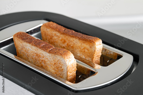 Healthy fashion food of breakfast. Toast in a toaster. Toaster with tasty breakfast toasts on the table