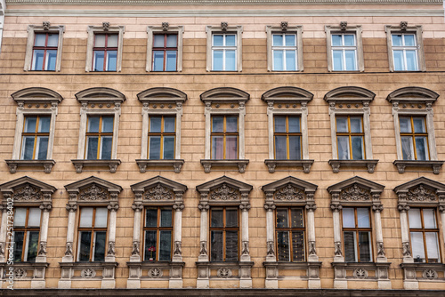 Vienna, Austria - December 27, 2017. Old european windows with molding and bas-reliefs on historic building facade.