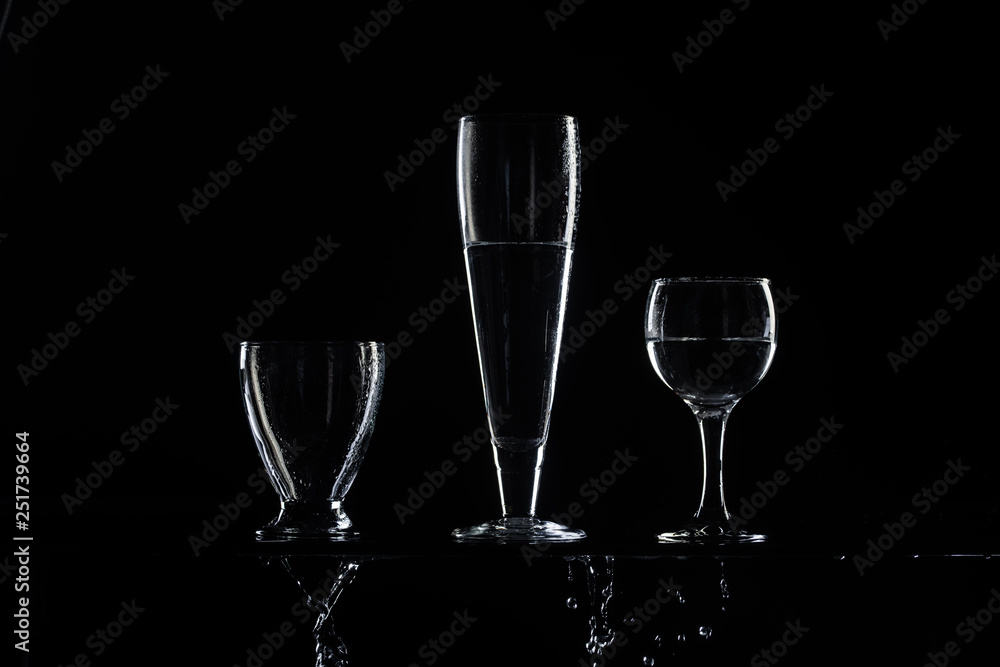 set of transparent glasses on black background 