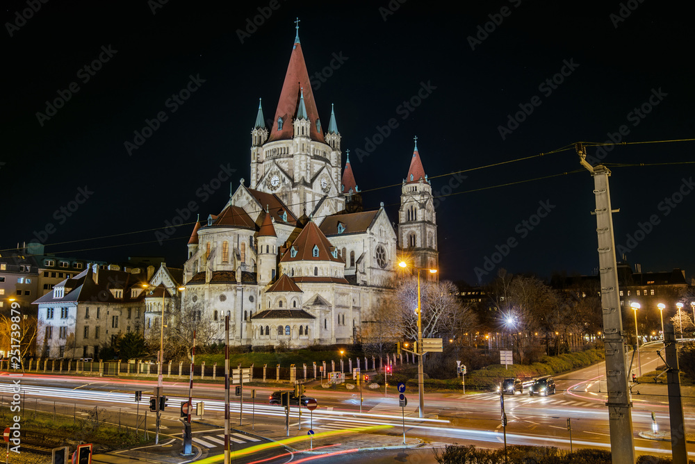 Obraz premium Vienna, Austria - December 29, 2017. St. Francis of Assisi Church, or Emperor's Jubilee Church, or Mexico Church, is Basilica-style Catholic church. Night view of Art Nouveau landmark building.