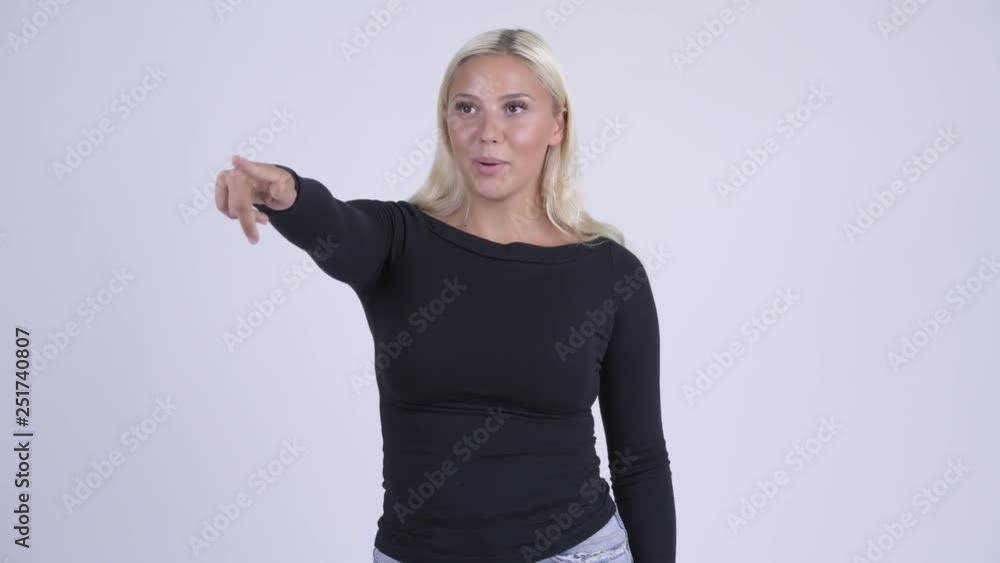 Young happy blonde woman pointing at distance Young happy blonde woman pointing at distance