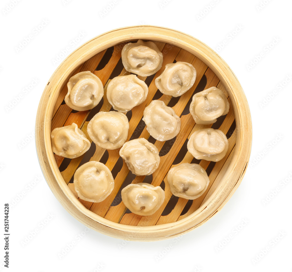 Steamer with tasty dumplings on white background Steamer with tasty dumplings on white background