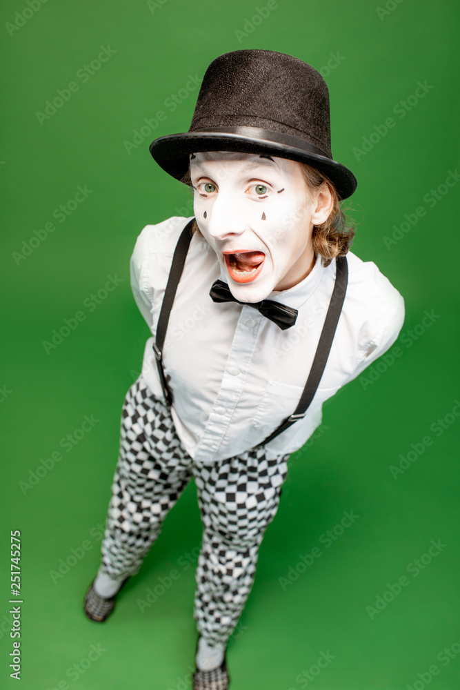 Full body portrait of an actor as a pantomime posing with expressive emotions isolated on the green background Full body portrait of an actor as a pantomime posing with expressive emotions isolated on the green background