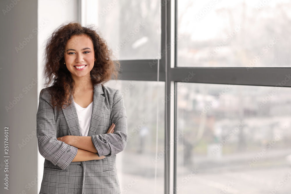 Portrait of young businesswoman near window in office Portrait of young businesswoman near window in office
