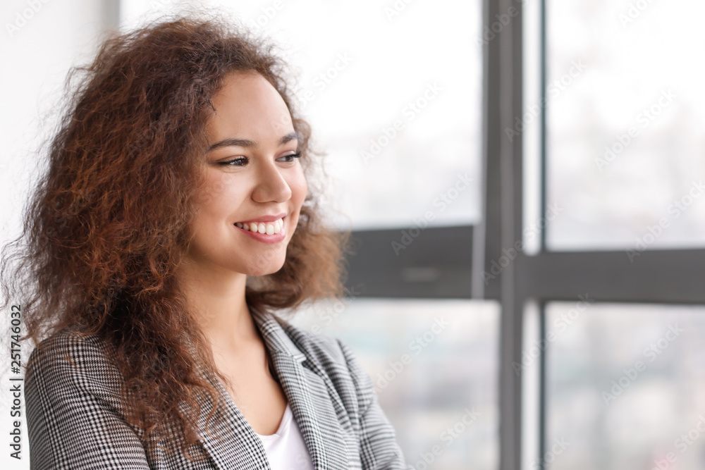 Portrait of young businesswoman near window in office Portrait of young businesswoman near window in office