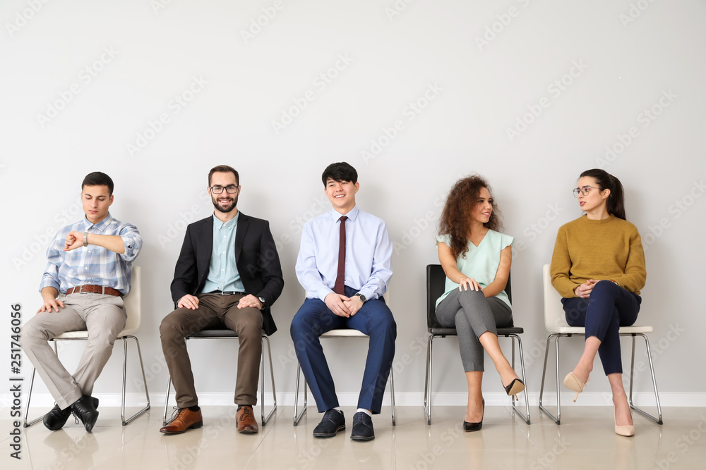 Young people waiting for job interview indoors - obrazy, fototapety, plakaty 