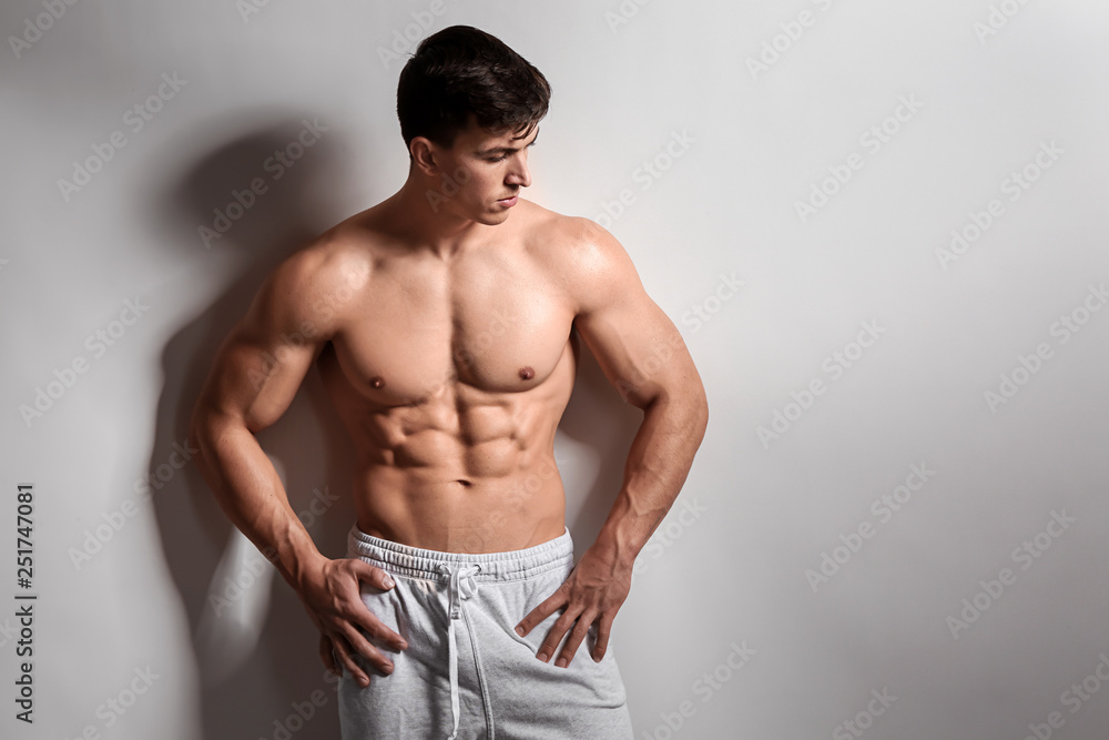 Muscular bodybuilder on light background