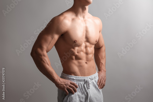 Muscular bodybuilder on light background