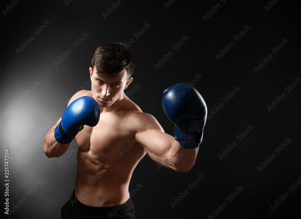 Attractive young boxer on dark background Attractive young boxer on dark background