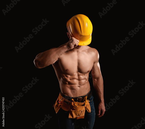 Muscular worker on dark background