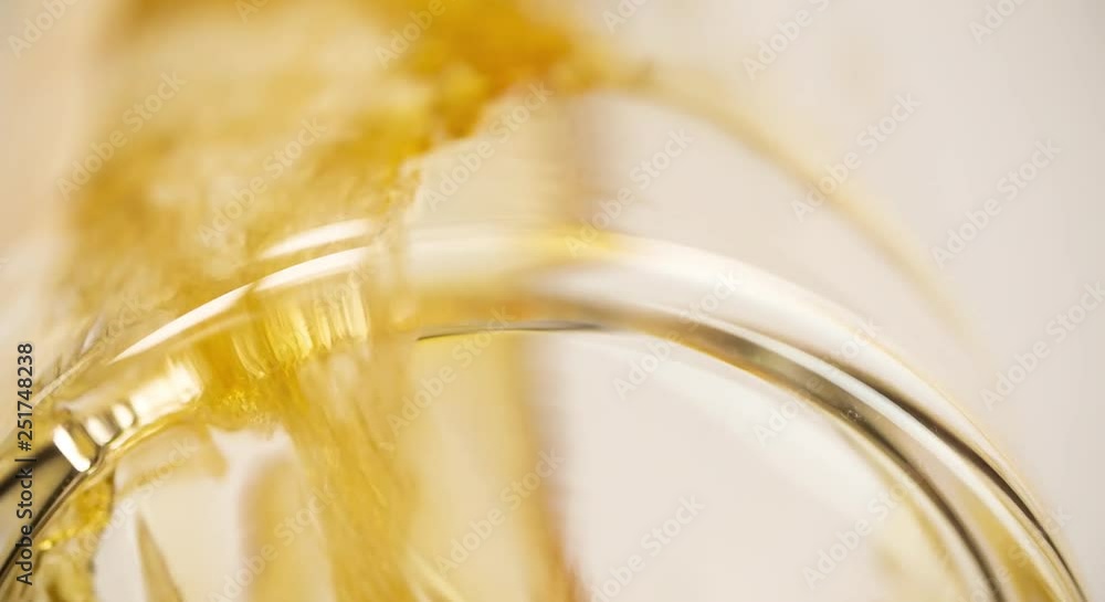 Beer is pouring and foaming in Glass from Bottom View Extremely closeup Slow motion video Beer is pouring and foaming in Glass from Bottom View Extremely closeup Slow motion video