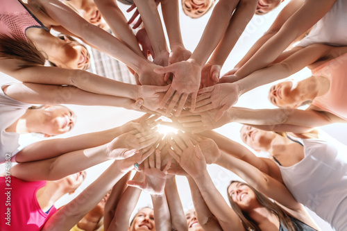 Canvas Print Bottom view of women stacking hands before exercising in gym.