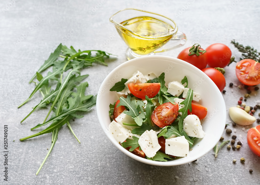 Italian cuisine. Vegetarian food. Salad with mozzarella, arugula and cherry tomatoes. Italian cuisine. Vegetarian food. Salad with mozzarella, arugula and cherry tomatoes.