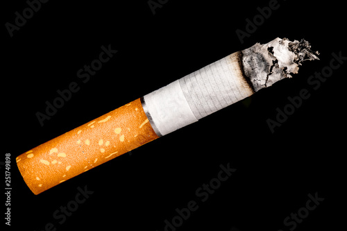 smoldering cigarette on a black background