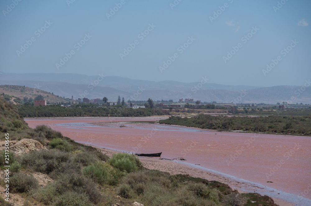 Red color Tensift river near Atlantic ocean coastline, Morocco