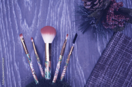 makeup brushes on wooden background