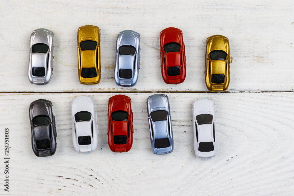 Cars toys on white wooden background. Top view Cars toys on white wooden background. Top view