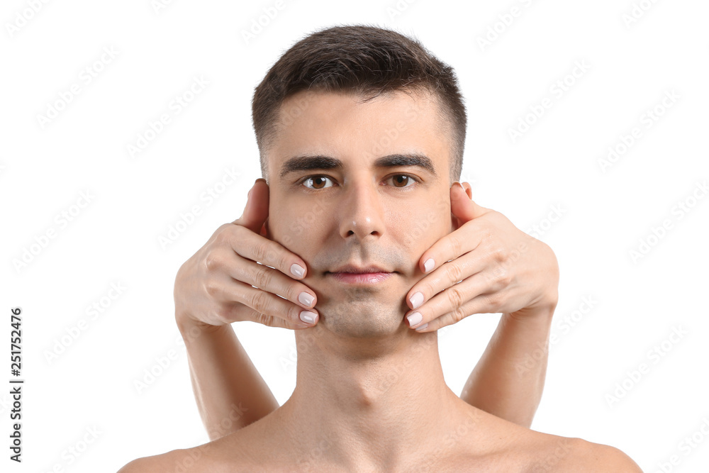 Handsome man receiving face massage on white background Handsome man receiving face massage on white background