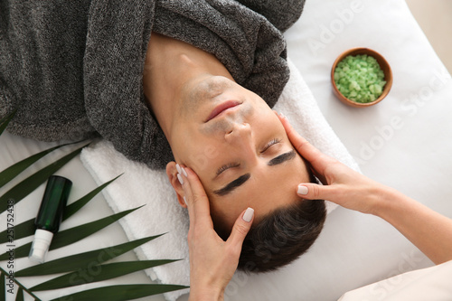 Man receiving face massage ...