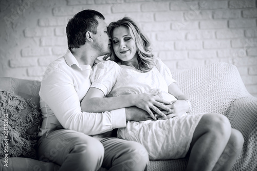 photo in retro style.portrait of happy husband with his pregnant wife