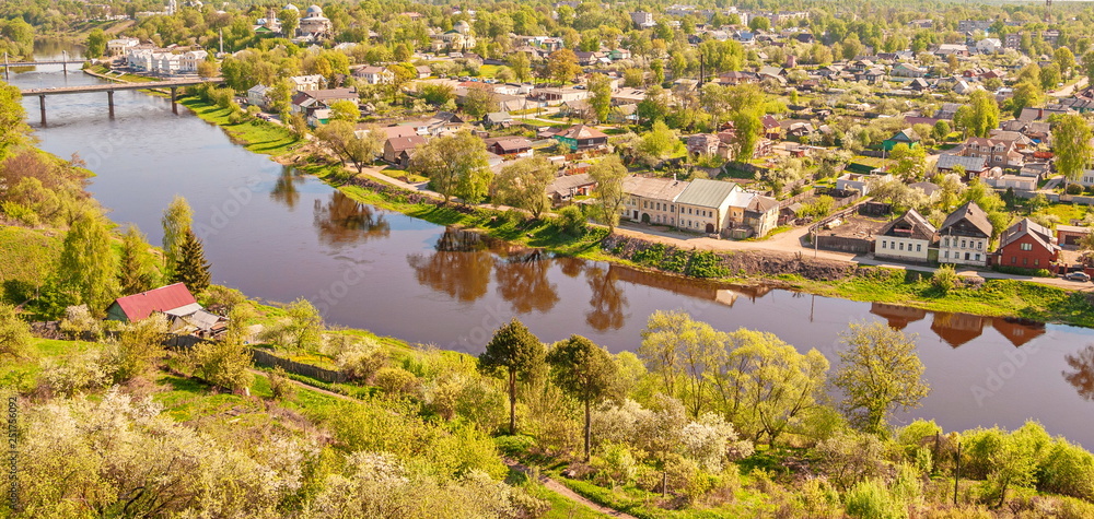 Fototapeta premium Small provincial town of Torzhok on bank of Tvertsa River in spring