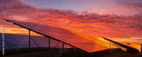 Solar power plant on the background of dramatic, fiery sky at sunset,Germany