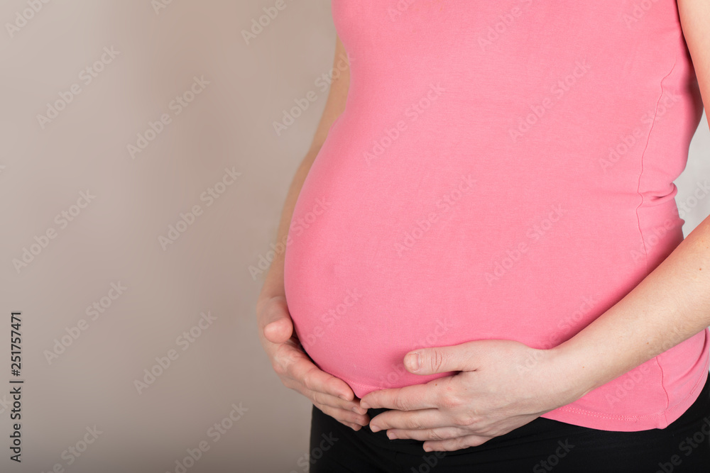 custom made wallpaper toronto digitalYoung pregnant woman keeps her hands at the belly. Closeup
