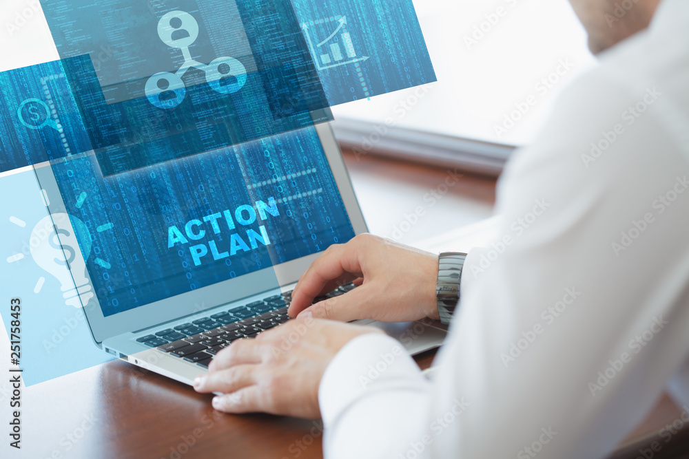 Business, technology, internet and networking concept. Young businessman working on his laptop in the office, select the icon action plan on the virtual display. Business, technology, internet and networking concept. Young businessman working on his laptop in the office, select the icon action plan on the virtual display.