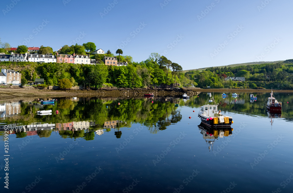 Reflection of boats on the water. Town Portree - Scotland