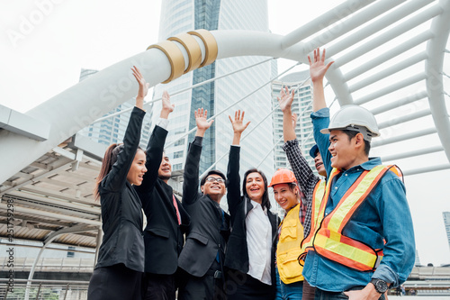 Group of international business and engineering partnership with hand raised up celebration of success