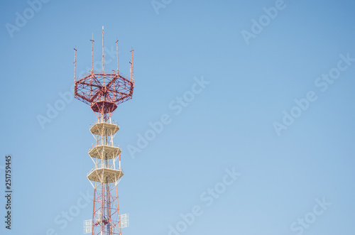 Technology communication tower ,TV Antenna, telephone connection at blue sky background.