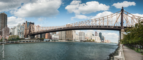 Very large panoramic view on  Queensboro Bridge over East River, manhattan`s midtown skyscrapers and Roosevelt island photo