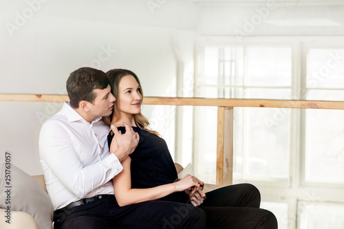 Young adult beautiful couple man and woman happy together in loft style interior
