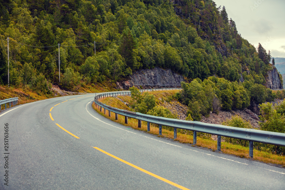 Driving a car on a winding mountain road. View of mountain road from the windshield. Nature of Norway Driving a car on a winding mountain road. View of mountain road from the windshield. Nature of Norway