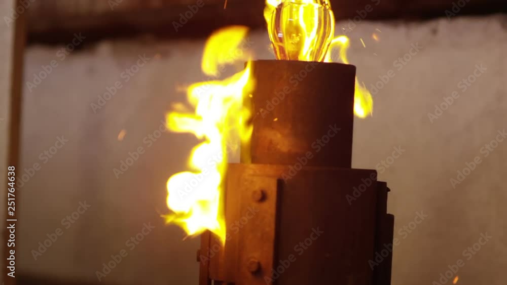 Glassworks manufacturing process . Production of glass bottles . Bottle manufacturing industrial factory . Molten glass . Glass factory . Process of creating glass products . Slow motion . Close up . Glassworks manufacturing process . Production of glass bottles . Bottle manufacturing industrial factory . Molten glass . Glass factory . Process of creating glass products . Slow motion . Close up .
