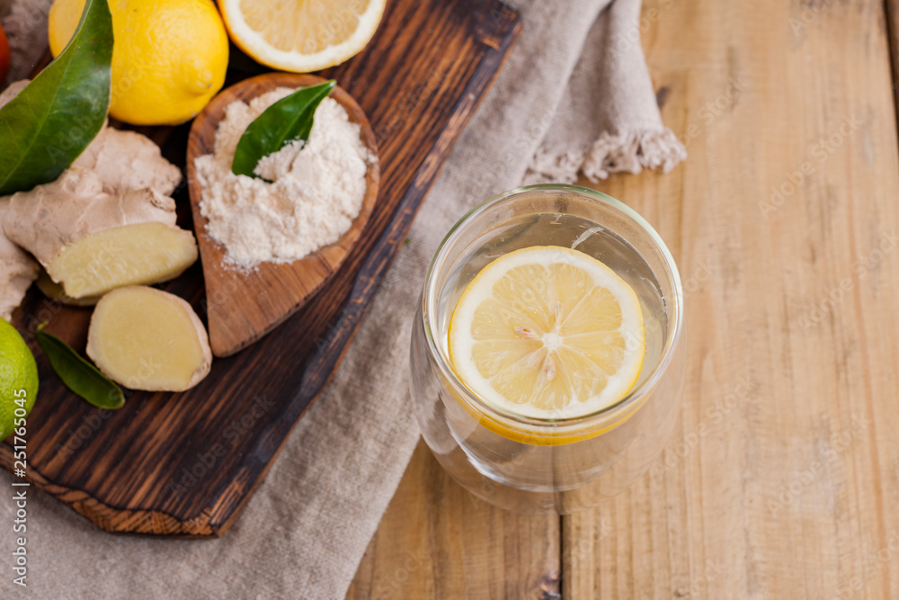 ginger, lemon and glass on a wooden background, Photo in rustic style. Ingredients for warming and health drink. Alternative medicine. Free space for text. ginger, lemon and glass on a wooden background, Photo in rustic style. Ingredients for warming and health drink. Alternative medicine. Free space for text.