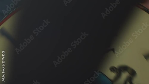 Pictures of man flipping back in zoetrope. Moving zoetrope drum through slit showing images of man doing backflip.