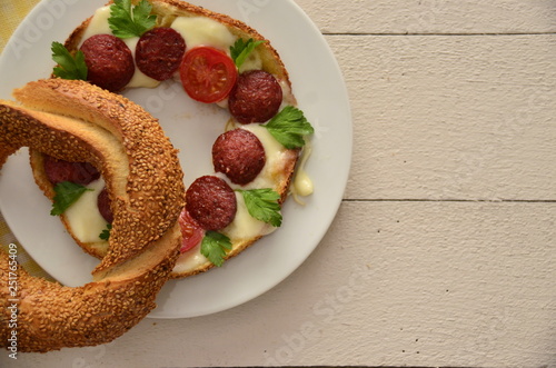 breakfast with bagel, cheese, sausage, tomatoand parsley photo