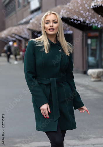 young stylish beautiful woman walking in street, wearing coat , fashion outfit, autumn trend.