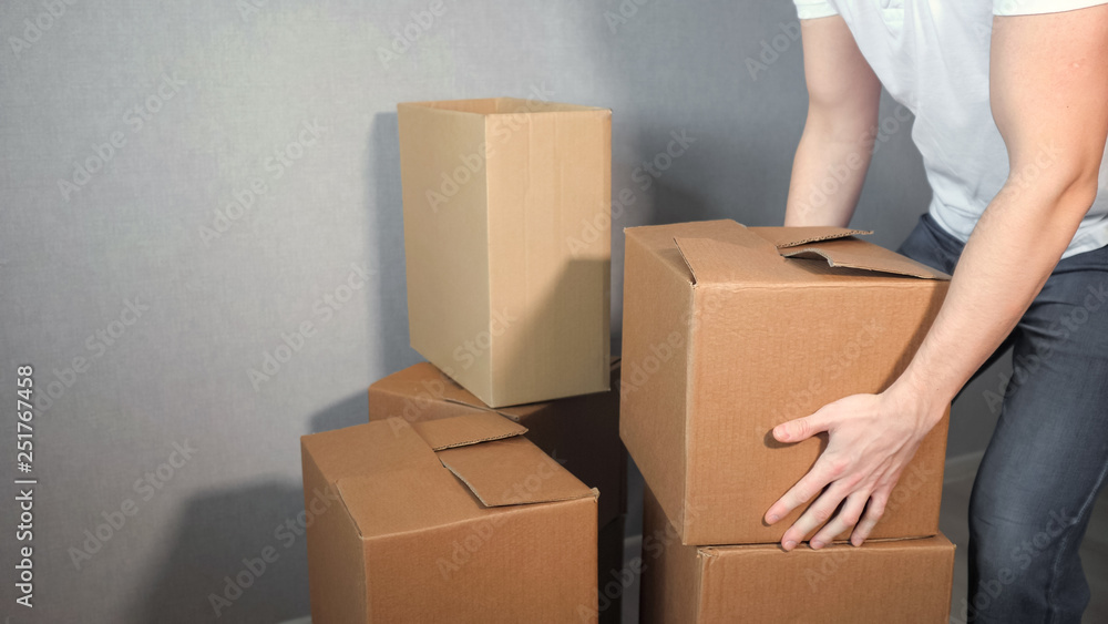 Young delivery service man takes a lot of cardboard Box. Young delivery service man takes a lot of cardboard Box.
