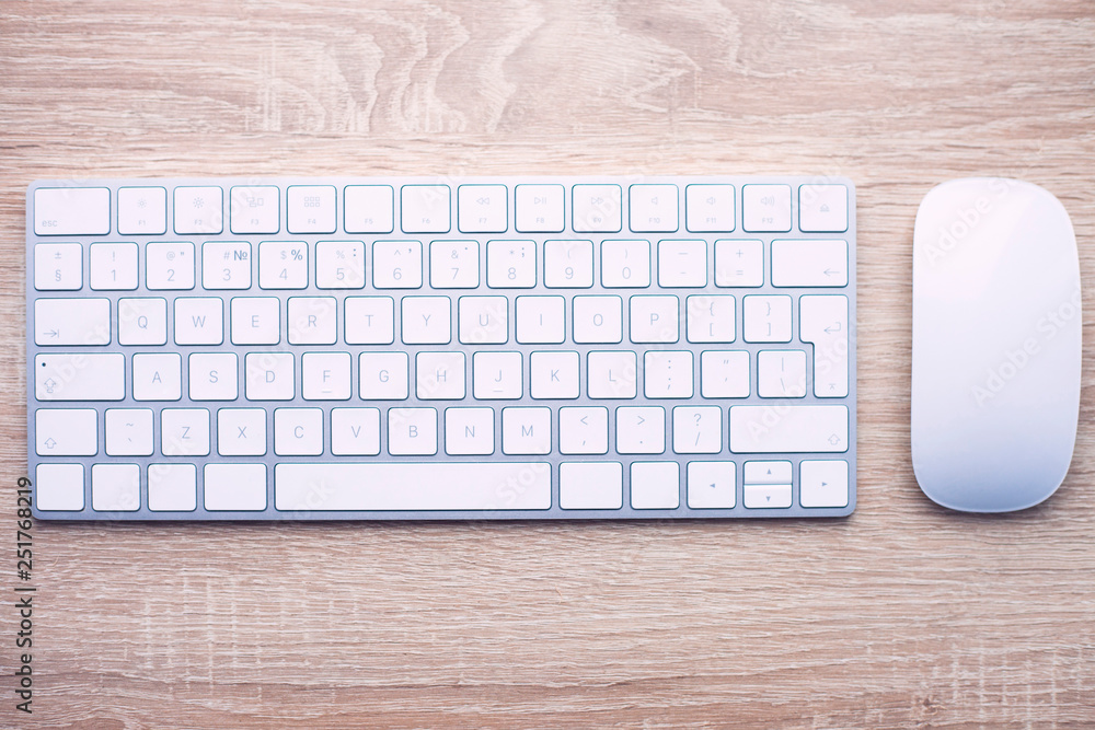 Work concept. White keyboard on the wooden table. The working process. Space for a text. Top view. Work concept. White keyboard on the wooden table. The working process. Space for a text. Top view.