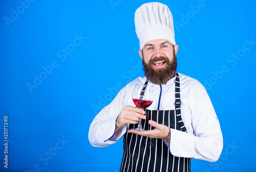 Which wine to serve with dinner. Sommelier enjoy wine. Excellent taste. Chef in cook hat and apron improve sommelier skill. Serving wine at restaurant. Drink alcohol. Hipster chef hold glass of wine © be free
