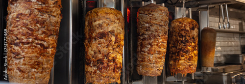 Gyros, doner grilled slowly on rotating spits. Traditional street food photo