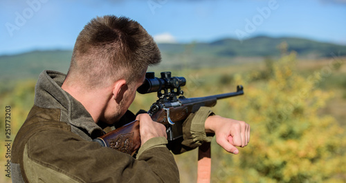 Brutal masculine hobby. Man aiming target nature background. Aiming skills. Hunter hold rifle aiming. On my target. Bearded hunter spend leisure hunting. Hunting optics equipment for professionals
