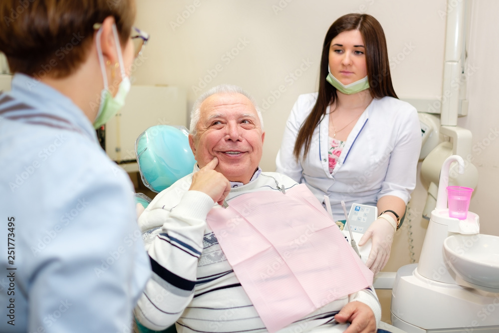 Senior man 70-75 years old, having visit to dental office for fixed toothache Senior man 70-75 years old, having visit to dental office for fixed toothache