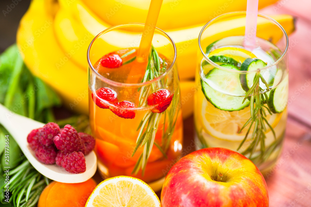 Fresh detox juices in glass bottles on the wooden background. Fruits and berries. Lifestyle, vegan food and drink, health care, diet and summer concept. Top view. Close up. Fresh detox juices in glass bottles on the wooden background. Fruits and berries. Lifestyle, vegan food and drink, health care, diet and summer concept. Top view. Close up.