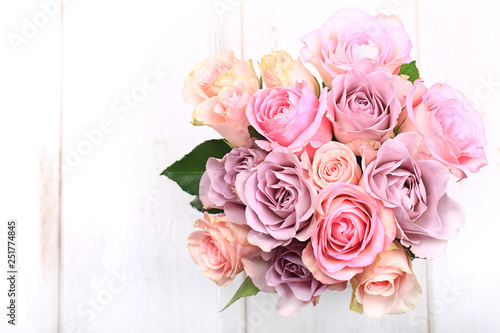 bouquet of roses on a white wooden background